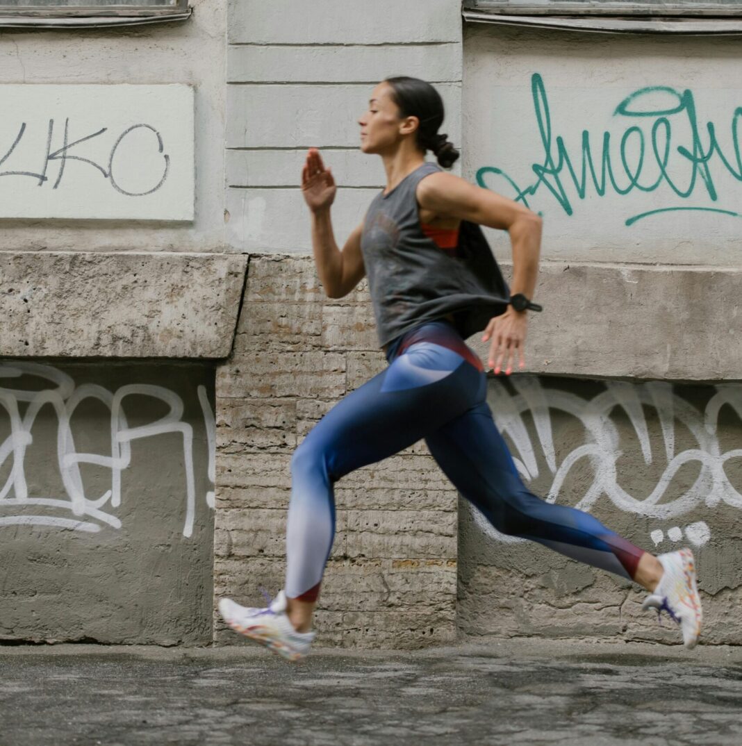A Side View of a Woman Jogging on the Street