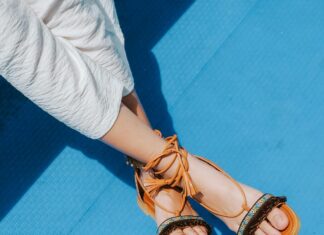 3 Spring Shoe Styles To Travel With Woman Wearing White Pants and sandals