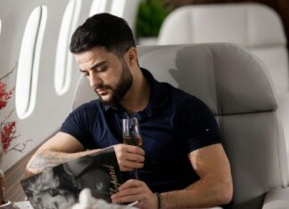 Best Place to Sit on Your Next Flight Man Sitting by Table on Airplane