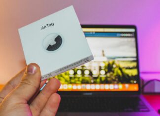 Why You Need AirTags For Your Next Trip AirTag Box Held by a Man