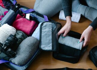 How to Pack for Changes in Weather Person Packing Clothes