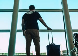 These Travel Bags Are Perfect Carry-Ons Man Holding Luggage Bag