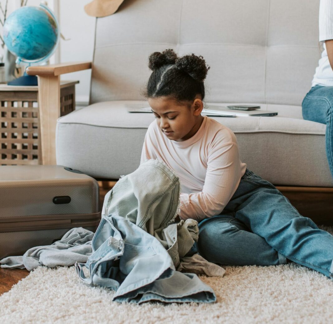 Mother and Daughter Sitting While Folding Clothes