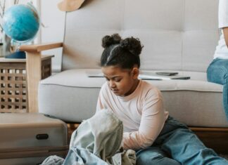 How to Save Space in Your Carry-On Luggage Mother and Daughter Sitting While Folding Clothes