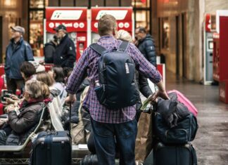 Best Safety Devices For a Secure Vacation Man holding several suitcases on the street