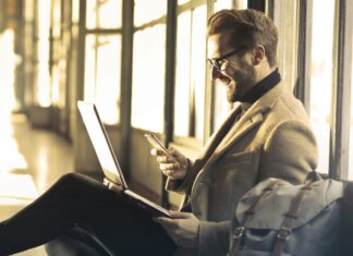 Countries That Offer Remote Work Visas Man sitting on the ground using a laptop