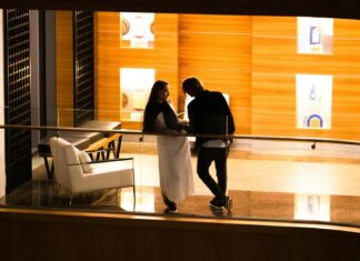 Enjoy Huge Hotel Discounts With Hopper Couple standing on a hotel balcony