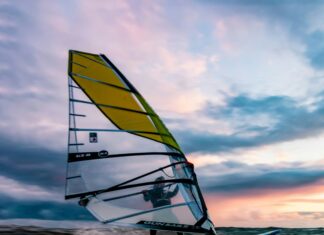 2 Best Countries for Windsurfing Man windsurfing during sunset