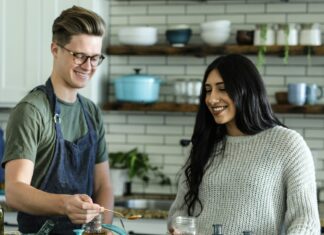Why You Should Take a Cooking Class On Your Next Vacation Man and woman cooking in a kitchen