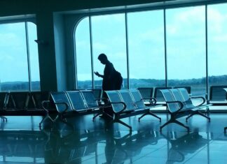 Make the Most of Your Long Layover With These Cool Ideas Grey Waiting Chairs and a Man