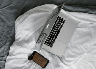 Unusual Travel Gadgets and Accessories You Might Need Silver Macbook Pro on White Bed Blanket