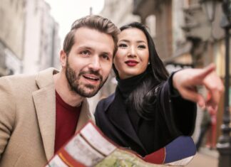Here’s Why Creating a Travel Itinerary is a Must Man in Brown Suit Standing Beside Woman Wearing Black Coat
