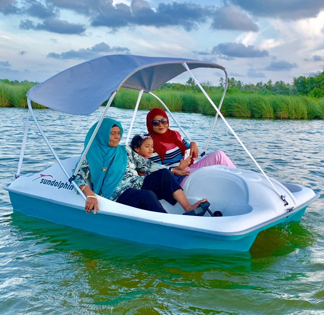 Woman riding a peddle boat in Dhadimagu Kilhi, Fuvahmulah, Maldives