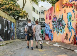 Ultimate Budget Backpacking Guide in South America Couple walking through a street lined with art