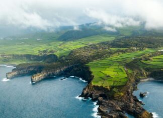 3 Reasons to Visit the Azores Aerial view of a grassy shoreline