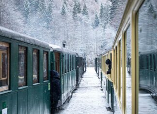 Here’s Why Traveling in Europe by Train is the Best Idea Two trains at a station in the snowy tundra