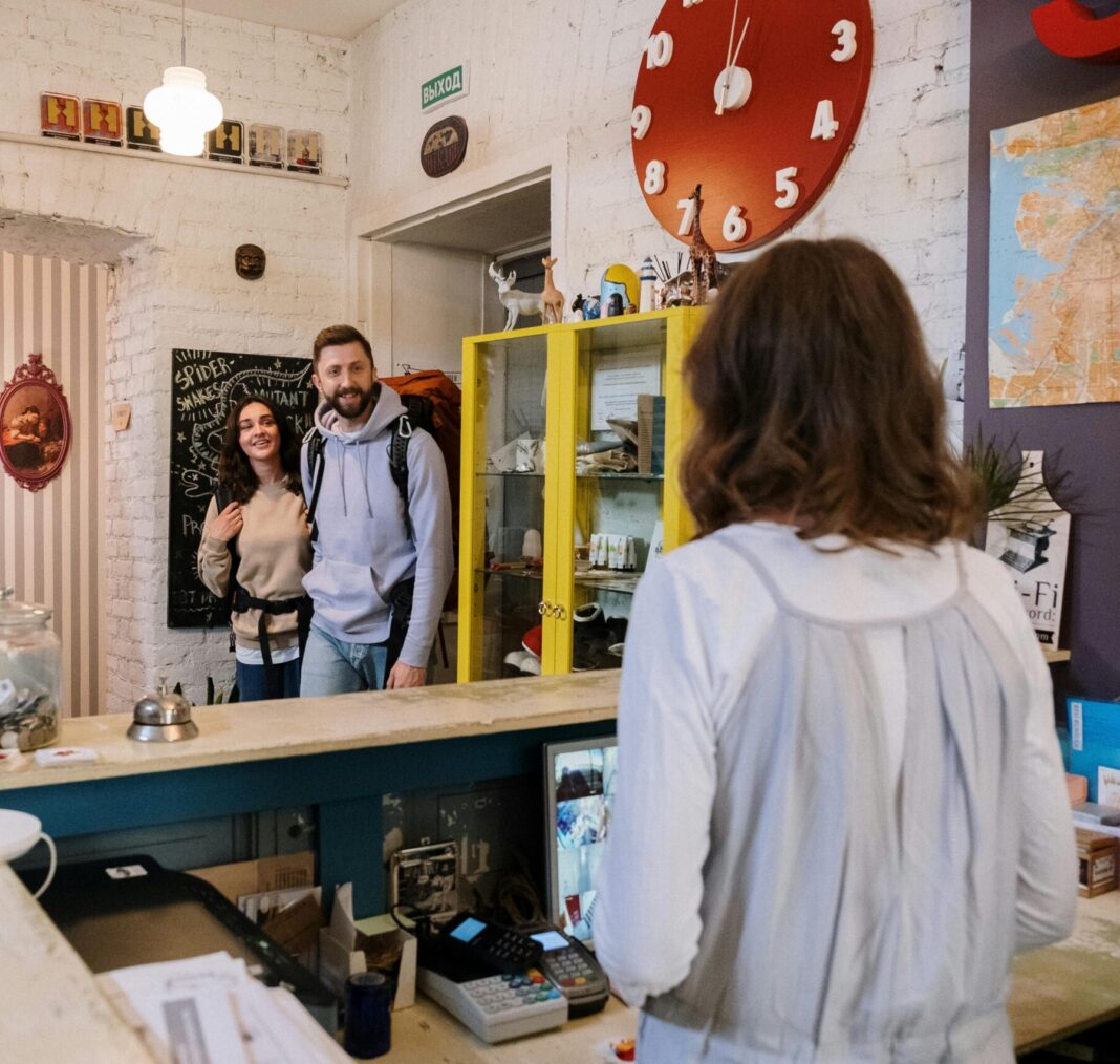 Backpackers Approaching Front Desk