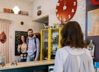 5 Reasons Why Hostels Are a Perfect Choice for Solo Travelers Backpackers Approaching Front Desk