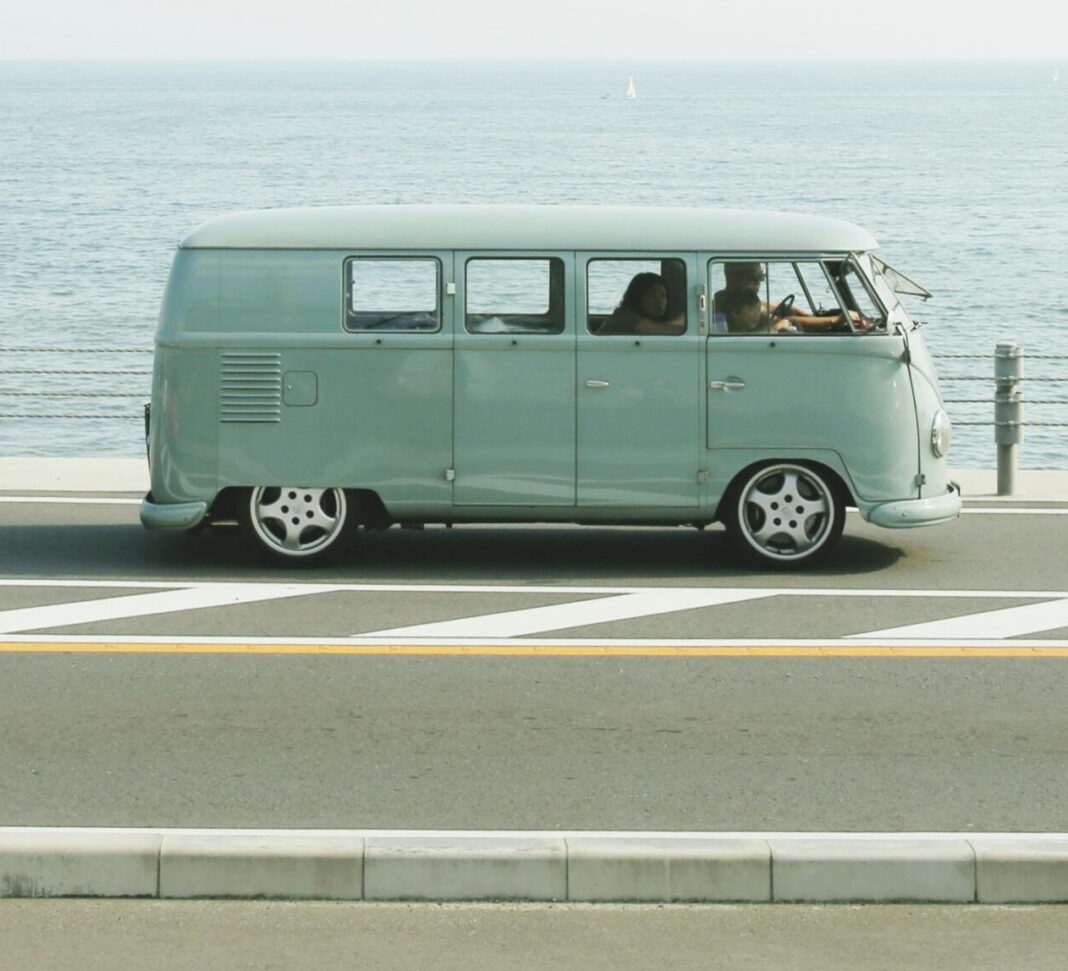 Van Parked Beside the Road Near Handrail and Ocean