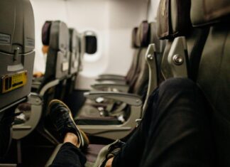How to Get a Neighbor-Free Seat on Your Flight Person Lying Down on Airline Seats