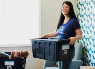 Easy Packing Hacks for Traveling With Kids Woman packing a box with her son